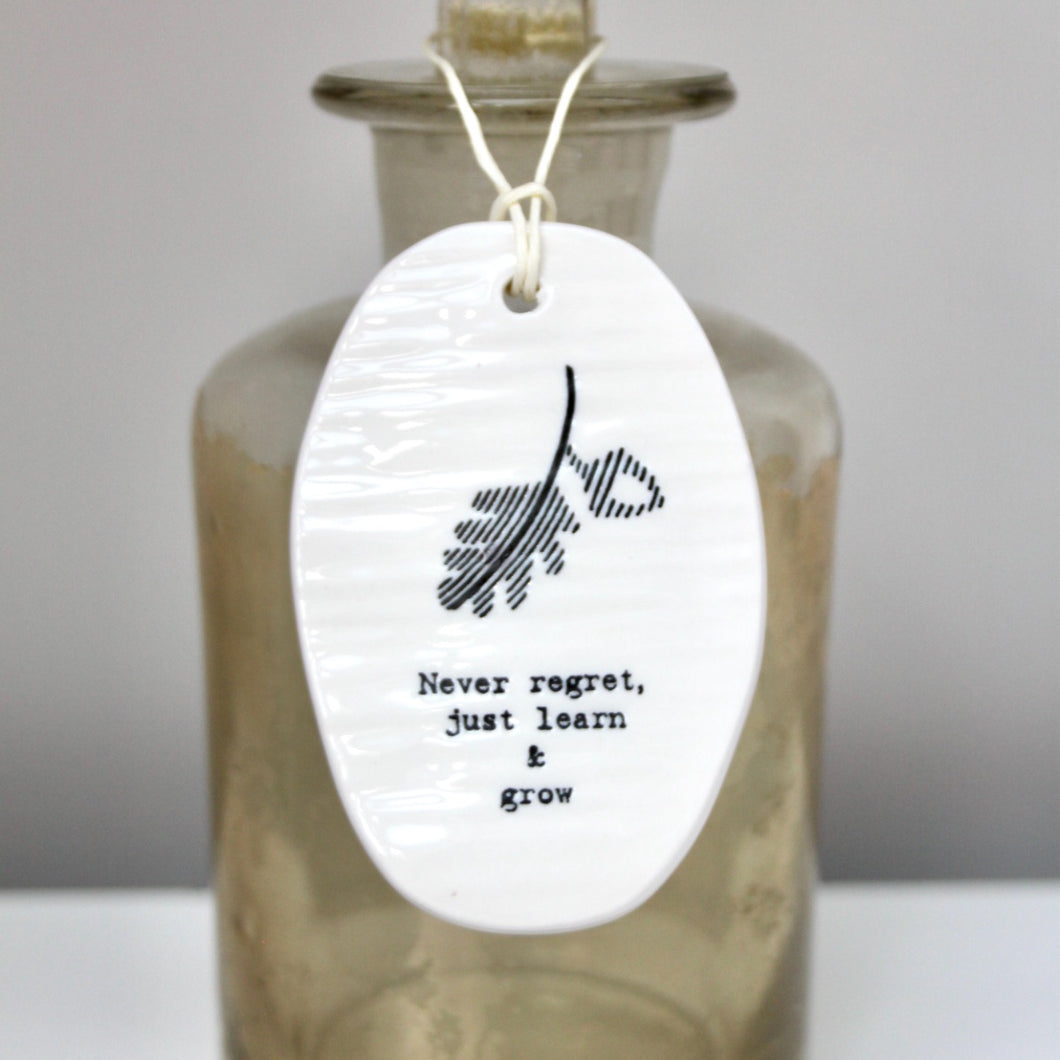 'Never regret, just learn and grow' Porcelain Tag Sign